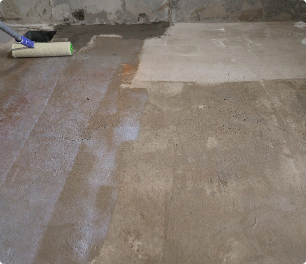 Concrete floor being primed for sealing