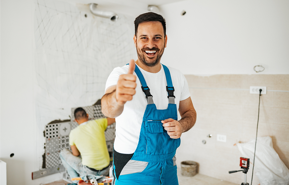 Smiling worker in blue overalls
