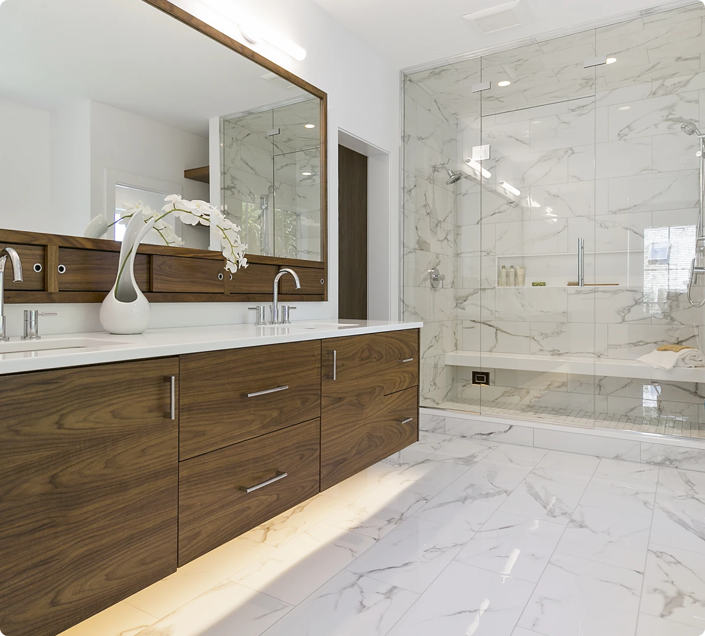 Elegant bathroom design with large mirrors.