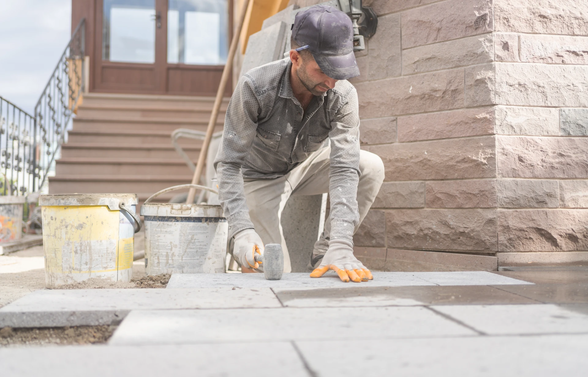 Construction worker placing paving stones
